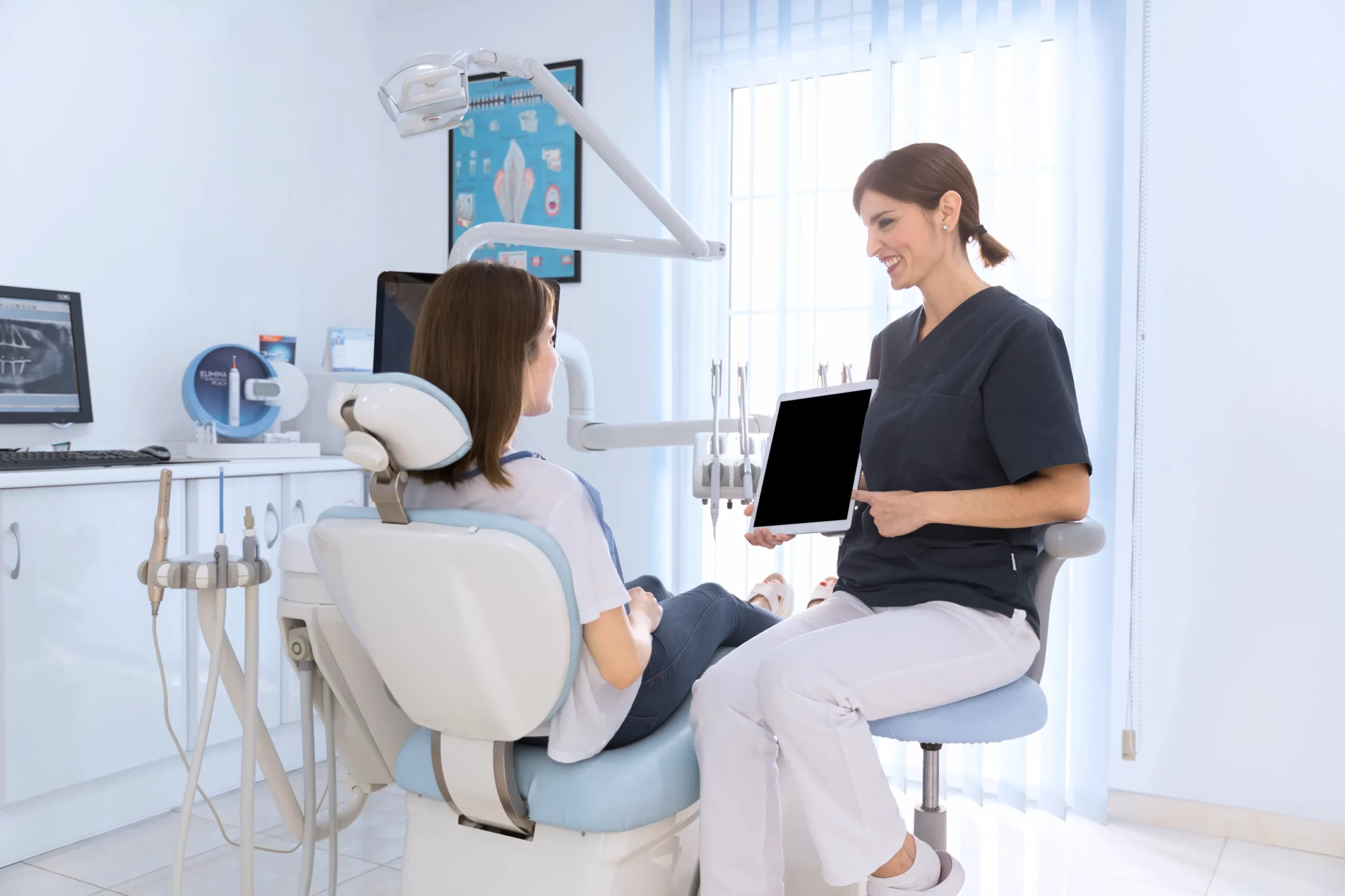 dentist-showing-digital-tablet-female-patient-clinic