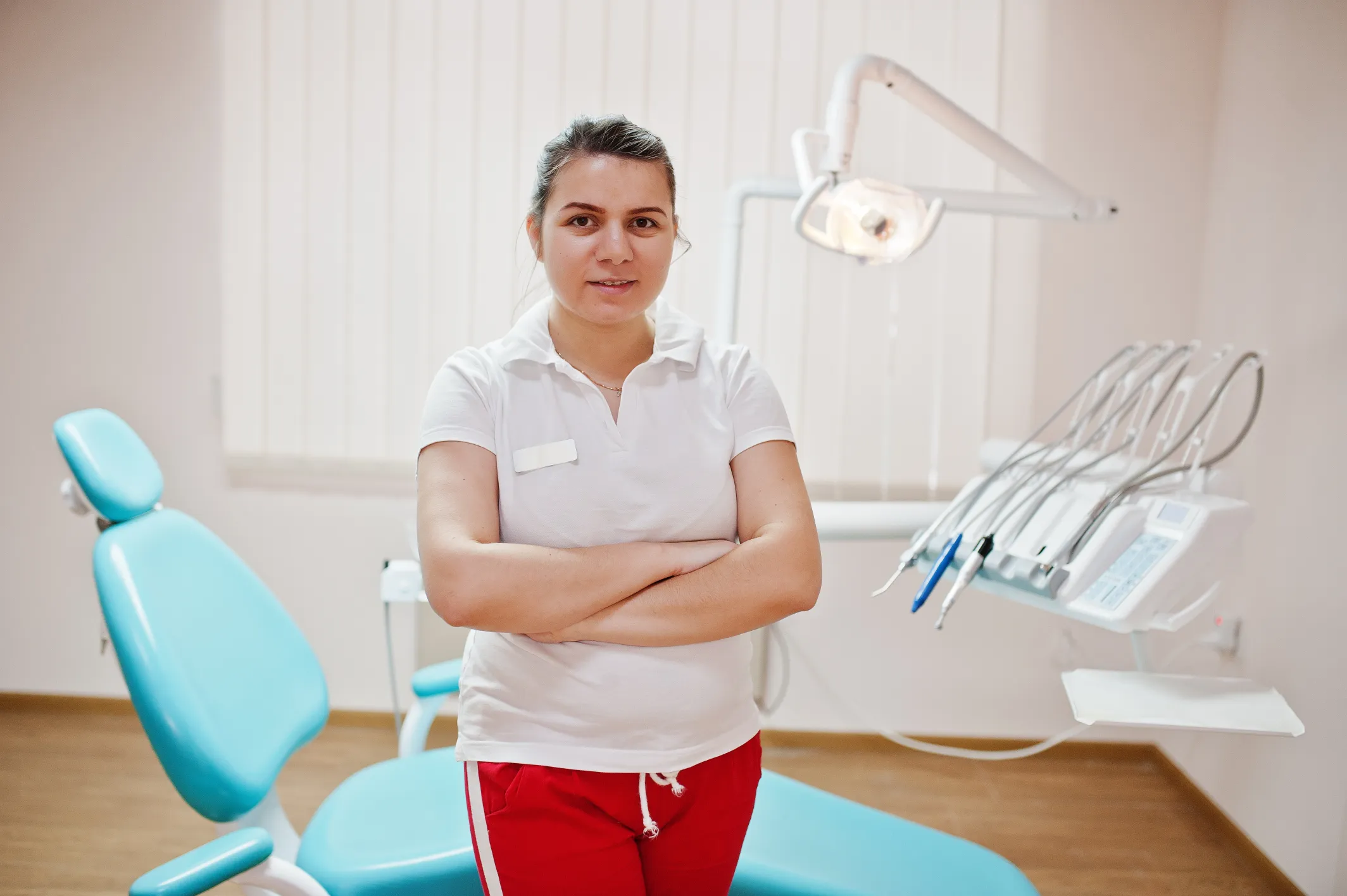 portrait-female-dentist-woman-crossed-arms-standing-her-dentistry-office-near-chair
